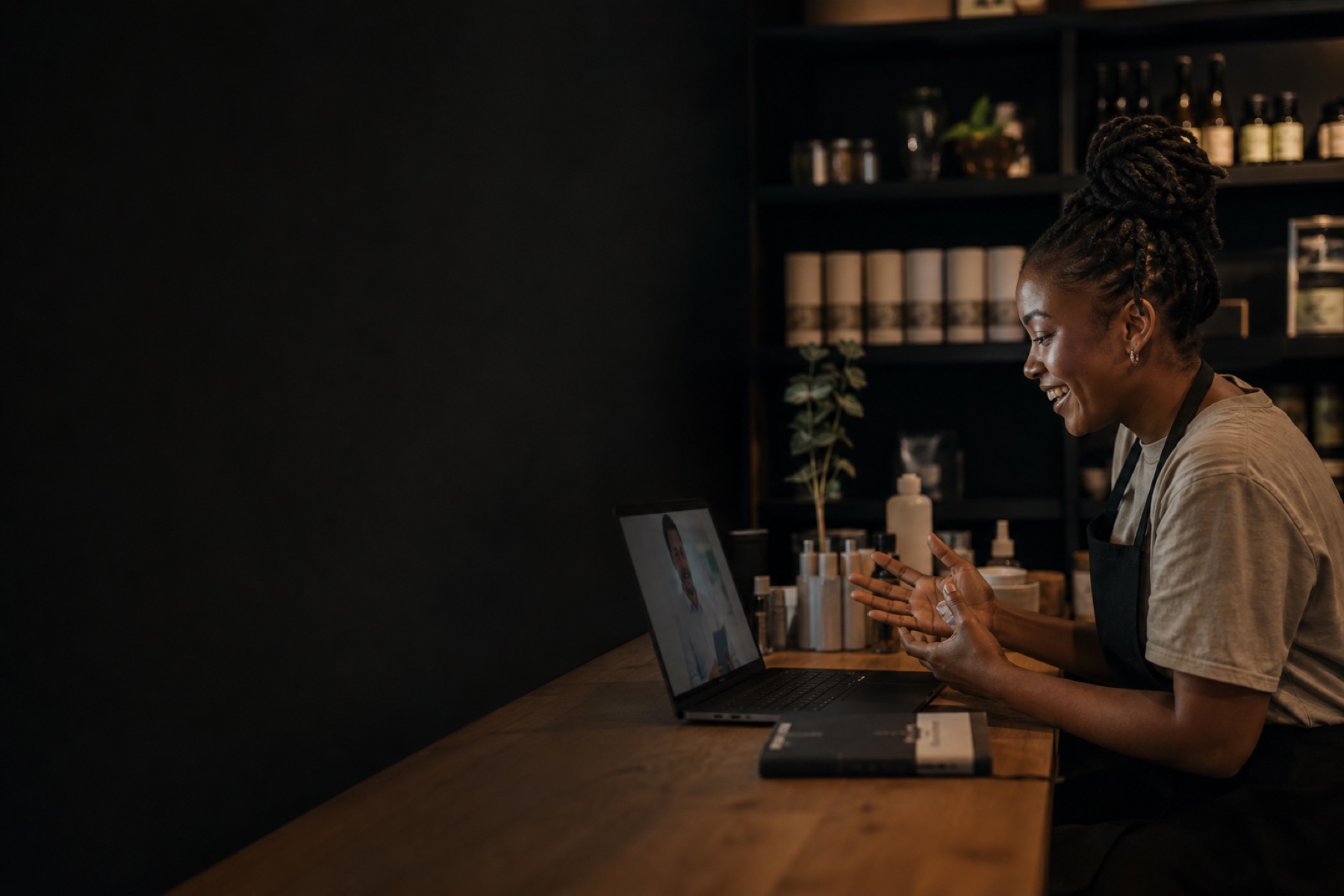 An independent shop owner having a friendly product video call from the counter.
